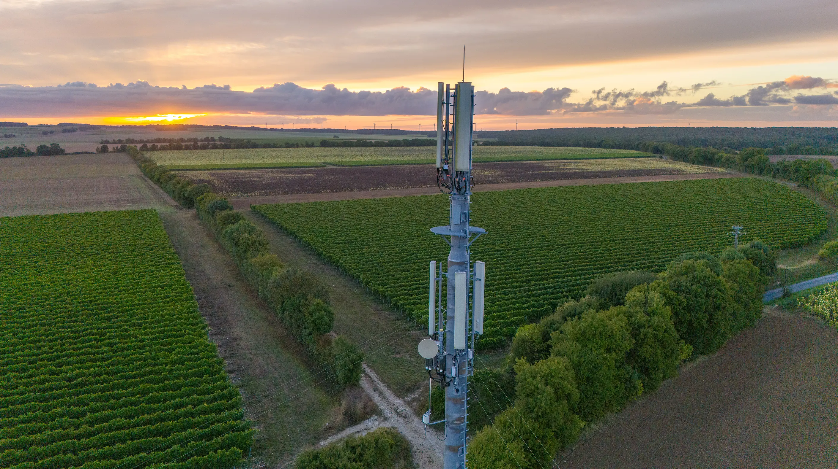 5G cell tower standing over a field in a rural location