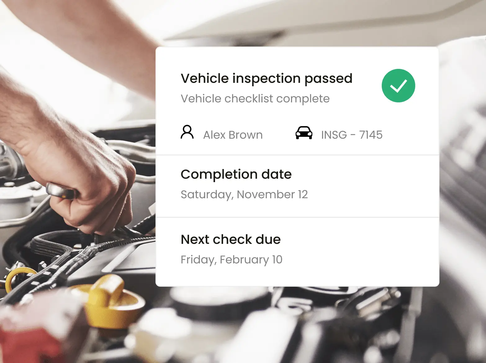 Closeup of a worker doing inspections on a vehicle with Inseego's fleet tracking software showing maintenance alerts about it.