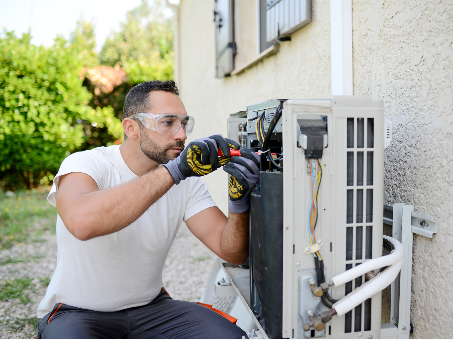 A person working on an air conditioner unit.