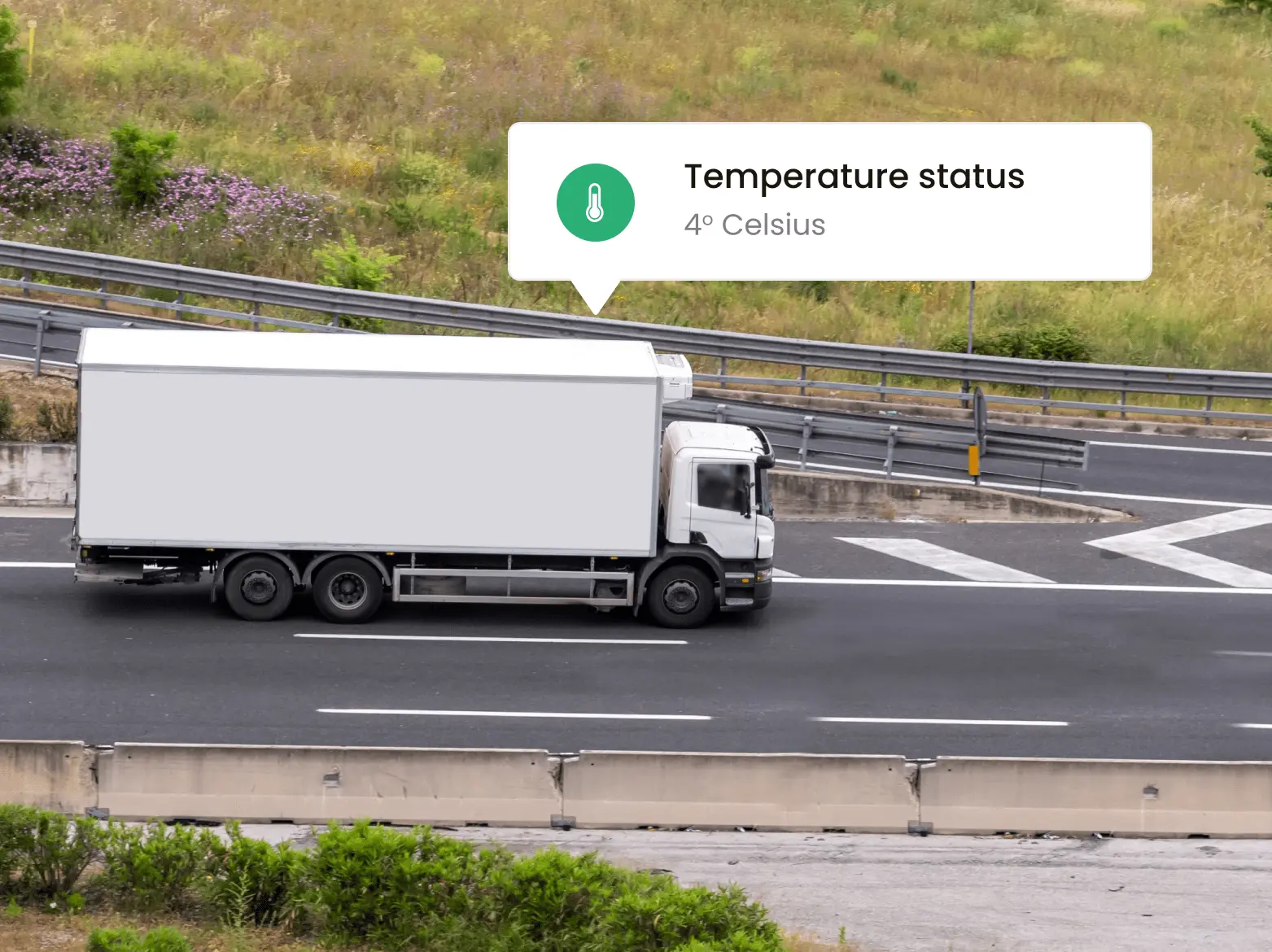 Picture of a truck driving down a road with a text box on the top right of picture showing the temperature.
